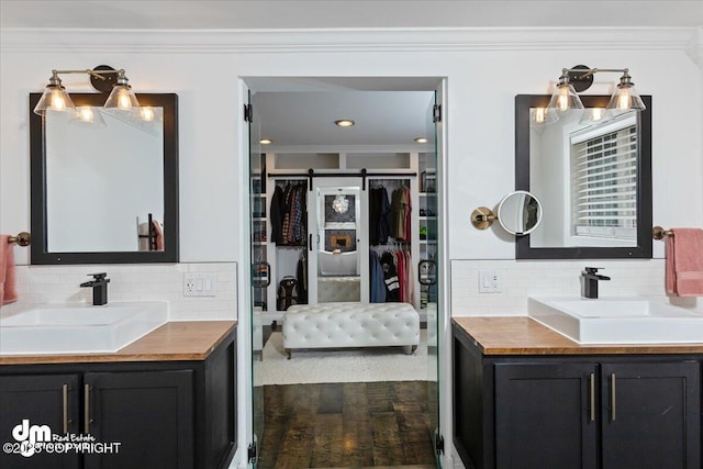 23231 Glacier View Dr, Eagle River, AK 99577 - bathroom with tasteful backsplash, ornamental molding, and a sink