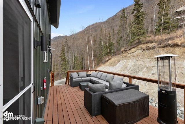 23231 Glacier View Dr, Eagle River, AK 99577 - wooden terrace with an outdoor hangout area, a mountain view, and a view of trees