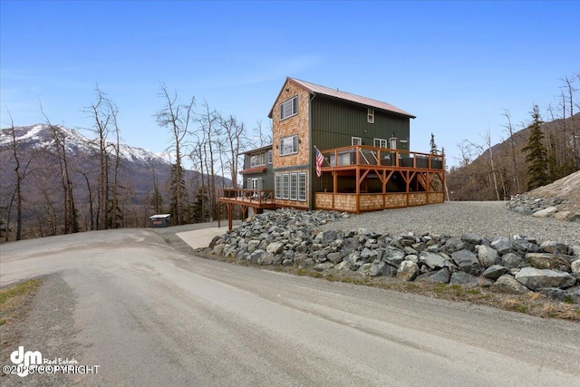 23231 Glacier View Dr, Eagle River, AK 99577 - rear view of house with metal roof and a deck with mountain view