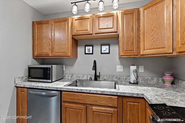 4530 Wright St # 15, Anchorage, AK 99507 - kitchen with a sink, appliances with stainless steel finishes, brown cabinets, and light countertops