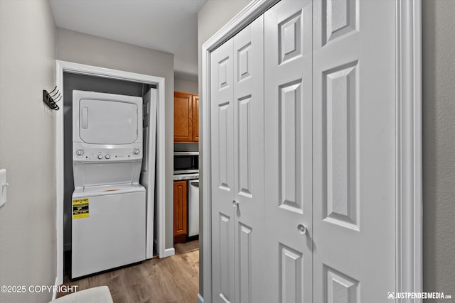 4530 Wright St # 15, Anchorage, AK 99507 - clothes washing area with stacked washer / drying machine, wood finished floors, and laundry area