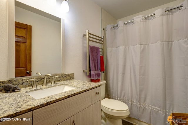 full bath featuring toilet, a shower with curtain, and vanity
