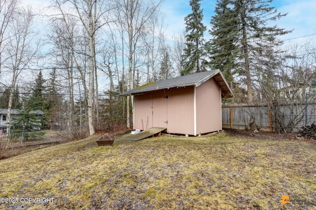 view of shed featuring fence