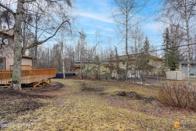 view of yard featuring fence and a wooden deck