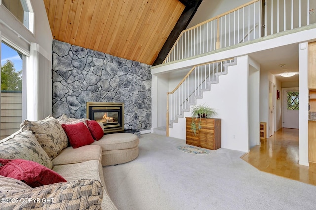 13120 Saunders Rd, Anchorage, AK 99516 - carpeted living area featuring high vaulted ceiling, stairway, wooden ceiling, and a stone fireplace
