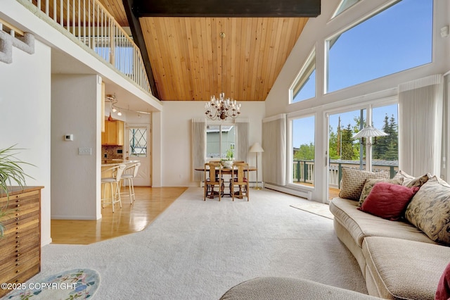 13120 Saunders Rd, Anchorage, AK 99516 - living area with a towering ceiling, light carpet, a chandelier, a baseboard heating unit, and wood ceiling