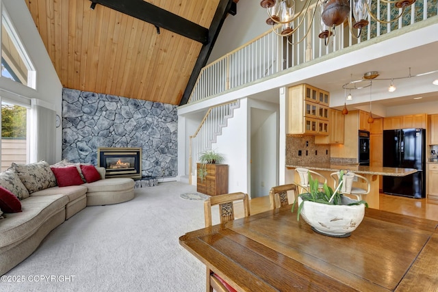 13120 Saunders Rd, Anchorage, AK 99516 - dining space with high vaulted ceiling, stairway, a stone fireplace, and wood ceiling with exposed beams