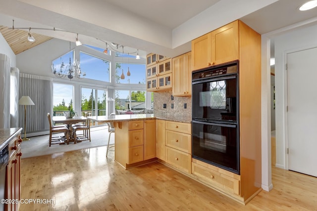 13120 Saunders Rd, Anchorage, AK 99516 - kitchen featuring black appliances, light brown cabinets, a peninsula, a chandelier, and vaulted ceiling