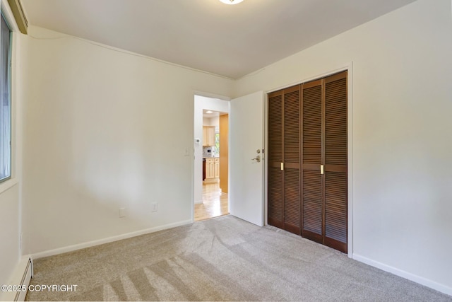 13120 Saunders Rd, Anchorage, AK 99516 - unfurnished bedroom featuring carpet, a closet, a baseboard heating unit, and baseboards