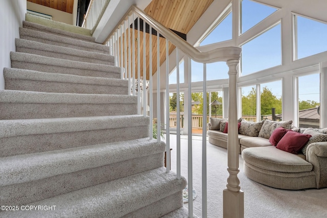 13120 Saunders Rd, Anchorage, AK 99516 - staircase with healthy amount of natural light, carpet flooring, and high vaulted ceiling