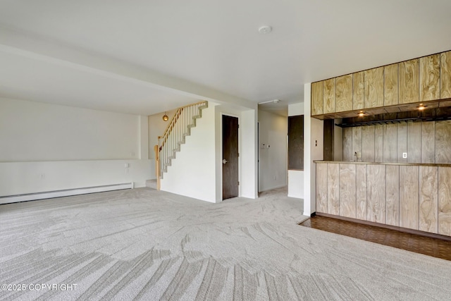 13120 Saunders Rd, Anchorage, AK 99516 - unfurnished living room featuring a baseboard radiator, stairs, and carpet floors