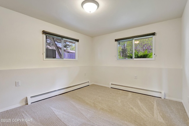13120 Saunders Rd, Anchorage, AK 99516 - carpeted empty room with a baseboard heating unit, plenty of natural light, and baseboards