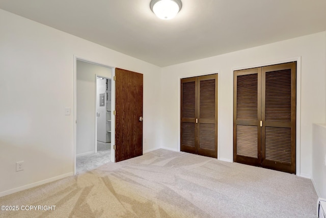 13120 Saunders Rd, Anchorage, AK 99516 - unfurnished bedroom featuring multiple closets, carpet floors, and baseboards