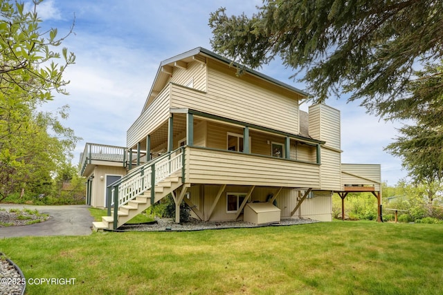 13120 Saunders Rd, Anchorage, AK 99516 - rear view of property featuring a lawn, stairway, a garage, and driveway