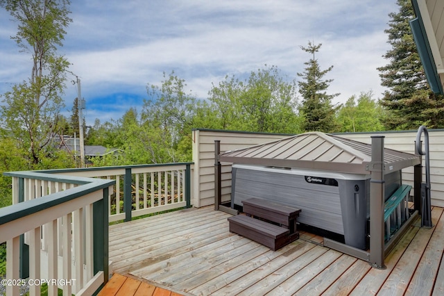 13120 Saunders Rd, Anchorage, AK 99516 - wooden deck with a hot tub and view of wooded area