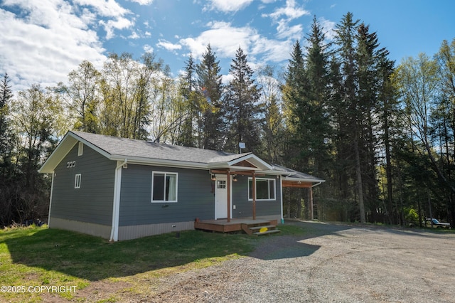 view of front of house featuring a porch and gravel driveway