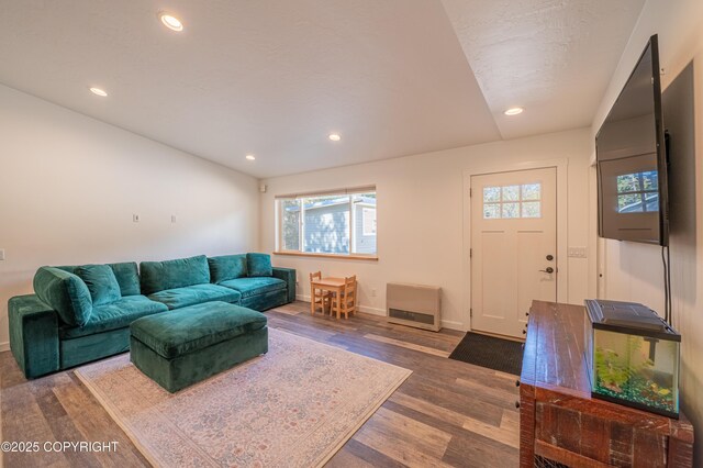 living area featuring wood finished floors, baseboards, and recessed lighting