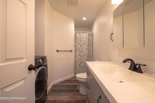 bathroom with washer / clothes dryer, wood finished floors, toilet, vanity, and recessed lighting