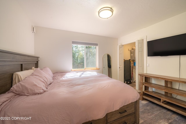 bedroom with dark wood-type flooring