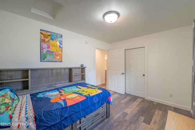 bedroom with wood finished floors and baseboards
