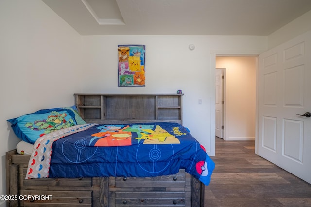 bedroom with wood finished floors and baseboards