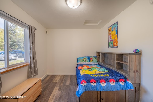 bedroom with wood finished floors and baseboards