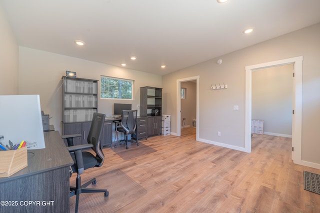 office space featuring light wood finished floors, baseboards, and recessed lighting