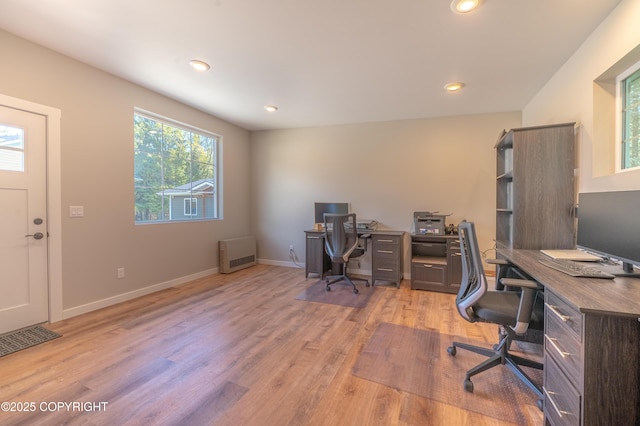 office featuring light wood-style flooring, recessed lighting, baseboards, and heating unit