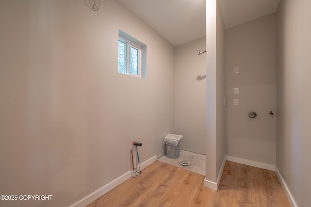 washroom with light wood-type flooring and baseboards