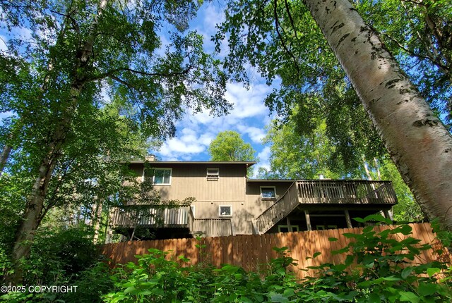19532 Ostovia Cir, Eagle River, AK 99577 - back of house with stairs, a wooden deck, and fence