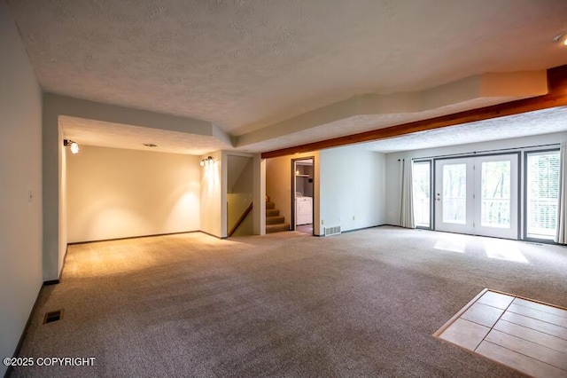 19532 Ostovia Cir, Eagle River, AK 99577 - carpeted empty room featuring a textured ceiling, baseboards, visible vents, and stairway