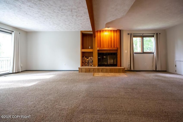 19532 Ostovia Cir, Eagle River, AK 99577 - unfurnished living room with a textured ceiling, carpet flooring, and a fireplace