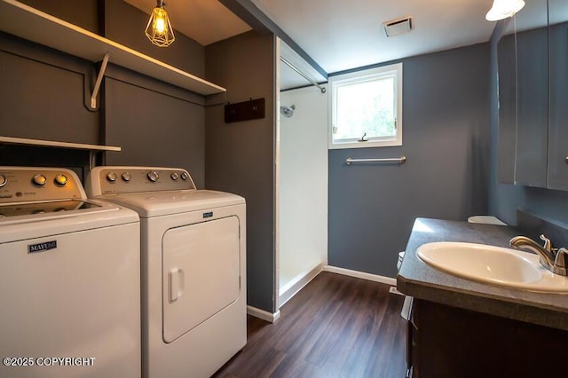 19532 Ostovia Cir, Eagle River, AK 99577 - laundry room with laundry area, separate washer and dryer, visible vents, a sink, and baseboards
