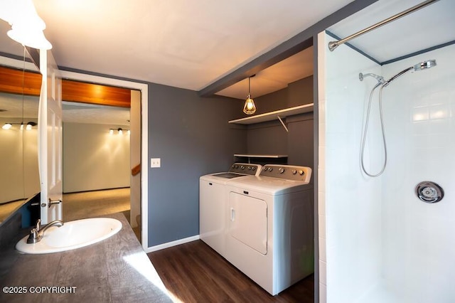 19532 Ostovia Cir, Eagle River, AK 99577 - washroom with laundry area, dark wood-type flooring, a sink, baseboards, and washing machine and dryer