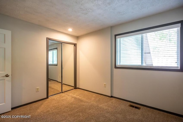19532 Ostovia Cir, Eagle River, AK 99577 - unfurnished bedroom featuring carpet floors, baseboards, multiple windows, and visible vents