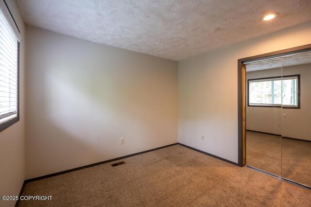 19532 Ostovia Cir, Eagle River, AK 99577 - unfurnished room featuring visible vents, baseboards, a textured ceiling, recessed lighting, and carpet flooring