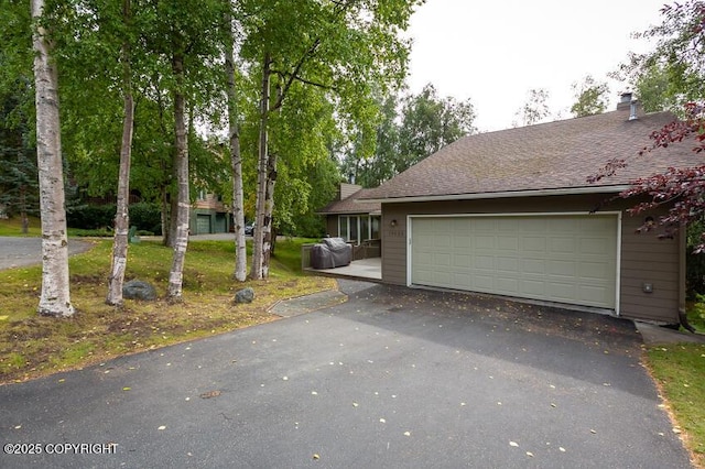 19532 Ostovia Cir, Eagle River, AK 99577 - view of front facade with a chimney, a front lawn, driveway, and roof with shingles