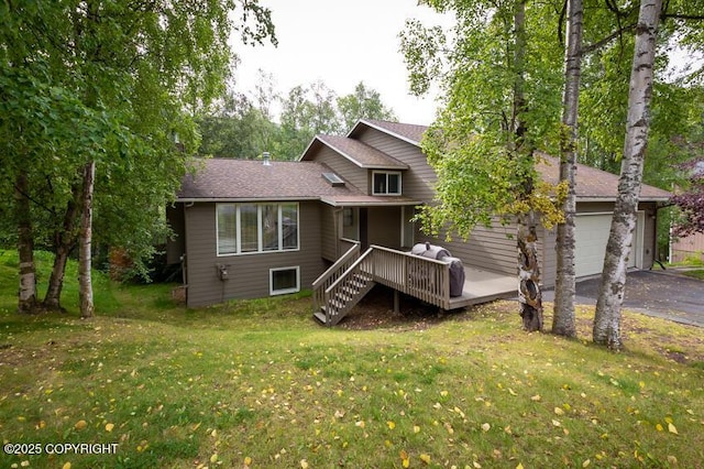19532 Ostovia Cir, Eagle River, AK 99577 - back of house featuring a yard, roof with shingles, an attached garage, driveway, and a deck