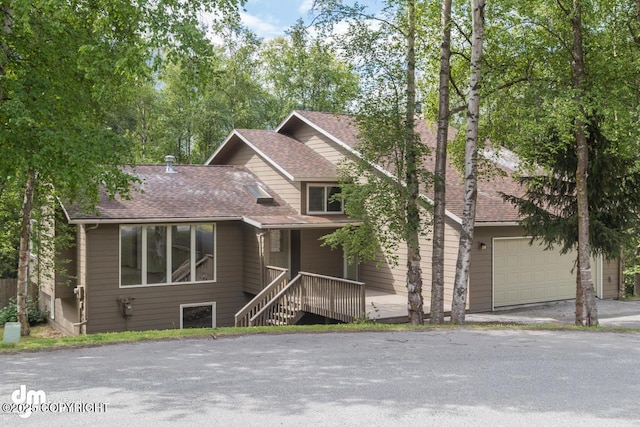 19532 Ostovia Cir, Eagle River, AK 99577 - view of front of house with a porch, an attached garage, and roof with shingles