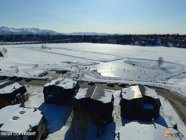 snowy aerial view with a mountain view
