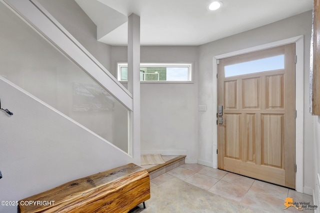 foyer with light tile patterned floors, recessed lighting, and stairs