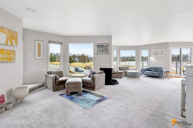 carpeted living area featuring recessed lighting and a wealth of natural light