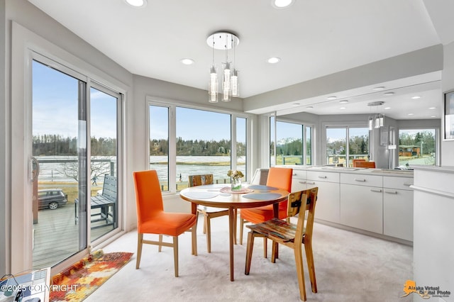 sunroom with a sink and a water view