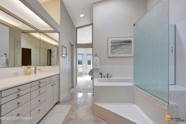 full bathroom with tile patterned flooring, vanity, recessed lighting, a towering ceiling, and a bath