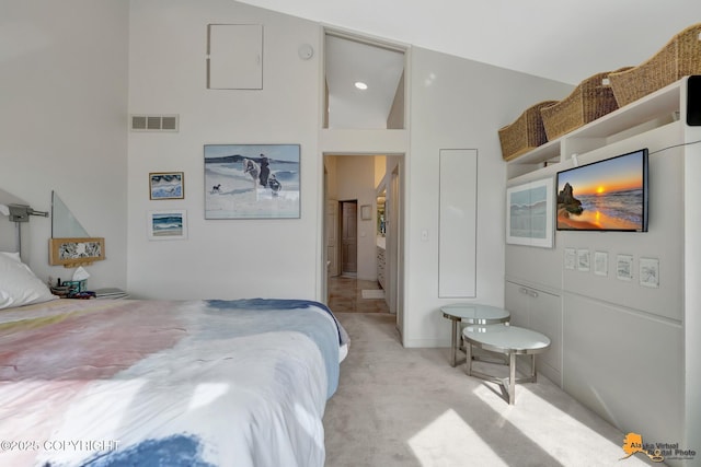 bedroom with visible vents and light carpet