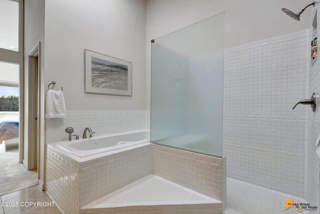 bathroom with tile patterned floors, tiled shower, and a garden tub