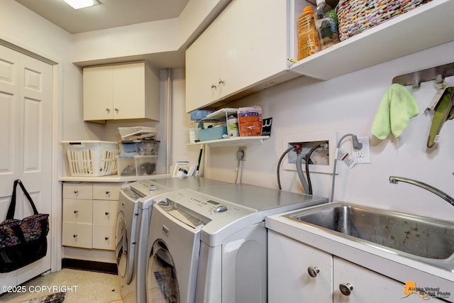 laundry area featuring cabinet space, a sink, and washing machine and clothes dryer