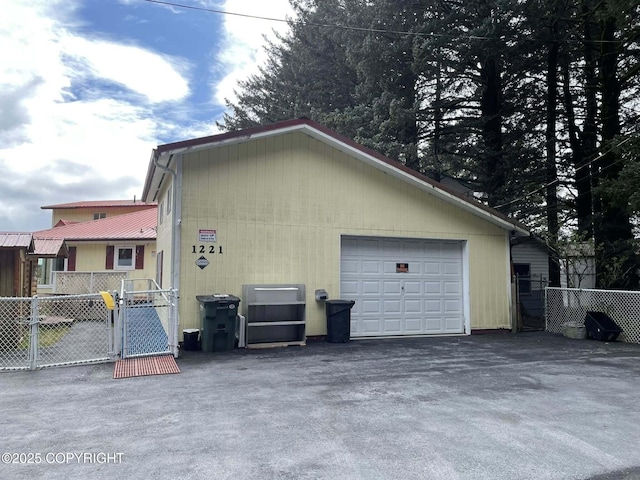 1221 W Kouskov St, Kodiak, AK 99615 - exterior space featuring driveway, a garage, fence, and a gate