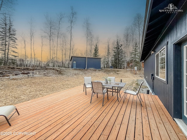 1340 N Rainbow Park Dr, Wasilla, AK 99623 - deck at dusk featuring outdoor dining space