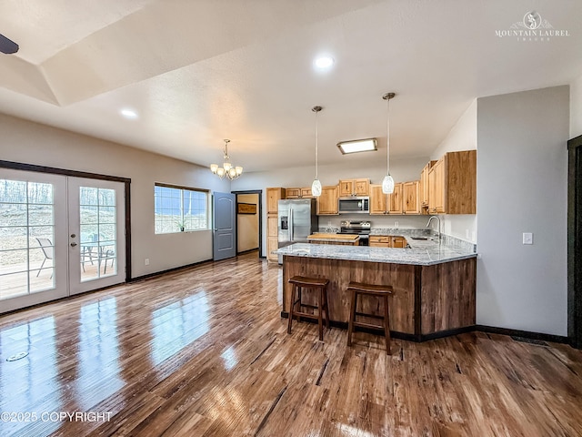 1340 N Rainbow Park Dr, Wasilla, AK 99623 - kitchen with a peninsula, appliances with stainless steel finishes, dark wood-type flooring, and baseboards